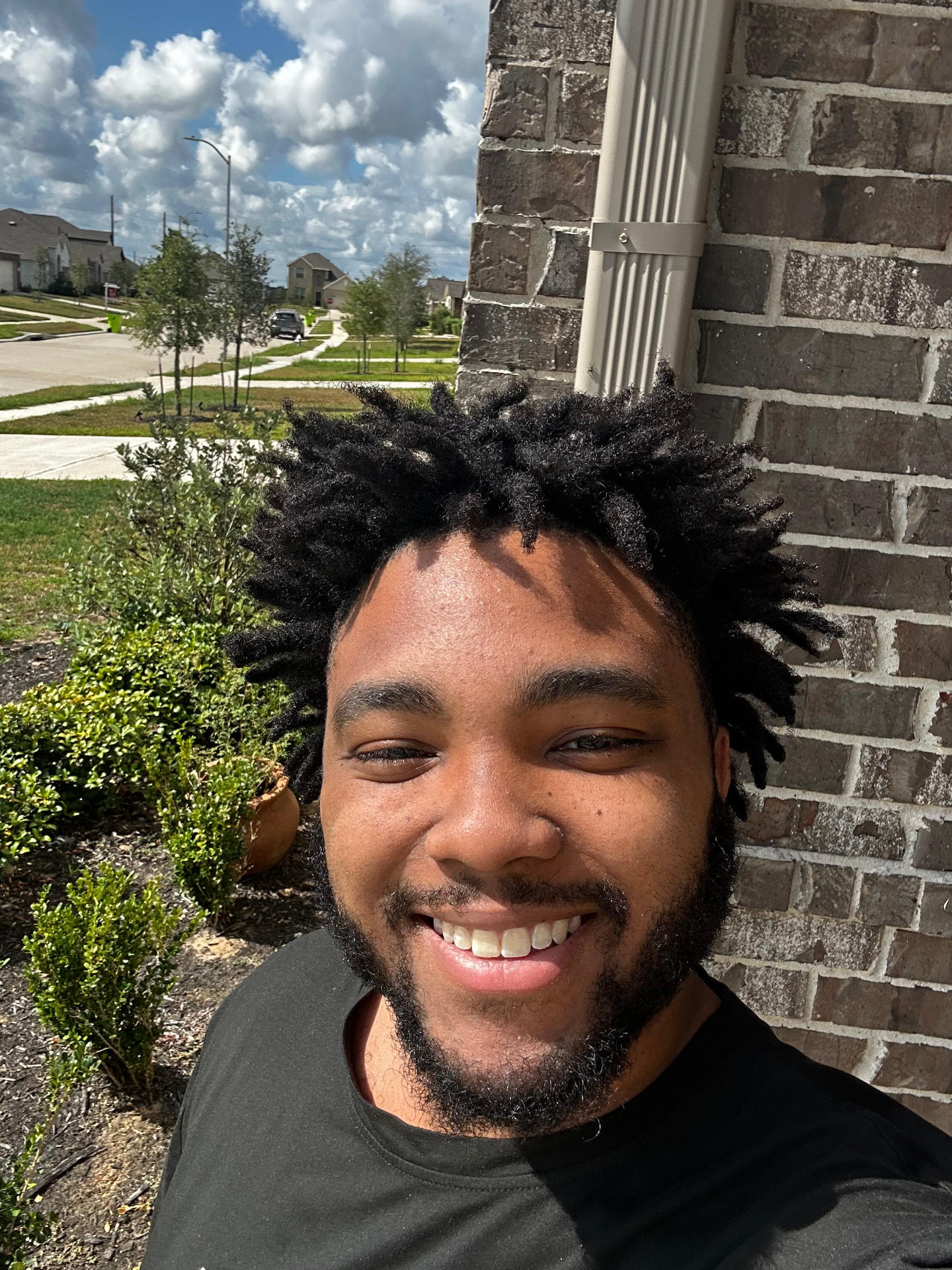 Ashton Henderson, founder of SMASH IT, smiling outside the venue